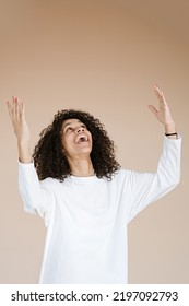 Yes! Pretty Extremely Happy African American Woman Celebrating Her Success With Raised Hands End Yelling Loud Glad Isolated Beige Background	                               