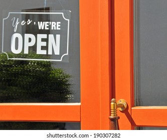 Yes, We Are Open Sign. Orange Wooden Door With A Glass