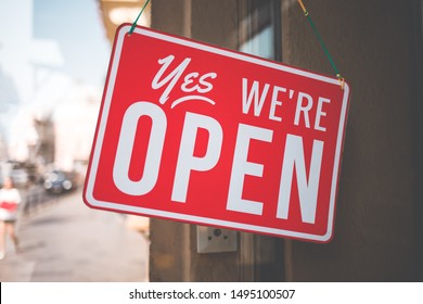 yes we're open sign on the glass of the doors in store.  welcome sign at the store - Shutterstock ID 1495100507