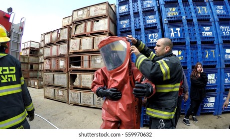 YESUD HAMAALA ISRAEL, MARCH 21, 2016: Firefighters Practice Sealing Of Leak Accident From Corrosive Toxic Hazardous Material Ammonia Liquid Container In Fruit Factory Dressing Protective Suites.