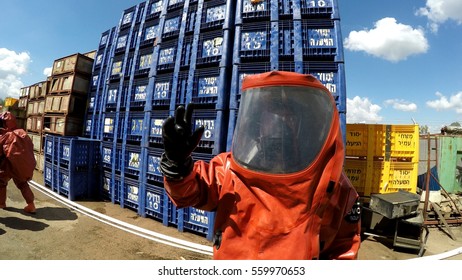 YESUD HAMAALA ISRAEL, MARCH 21, 2016: Firefighters Practice Sealing Of Leak Accident From Corrosive Toxic Hazardous Material Ammonia Liquid Container In Fruit Factory Dressing Protective Suites.