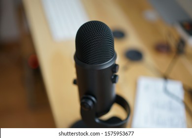 Yeti Microphone With A Blurred Out Background Of A Desk