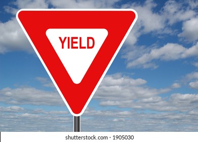 Yield sign with clouds in the background