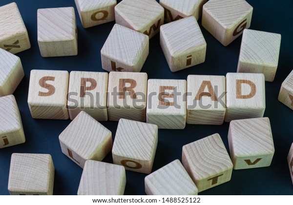 Yield spread, the difference between stock return\
and fixed income return concept, cube wooden block with alphabet\
combine the word Spread.