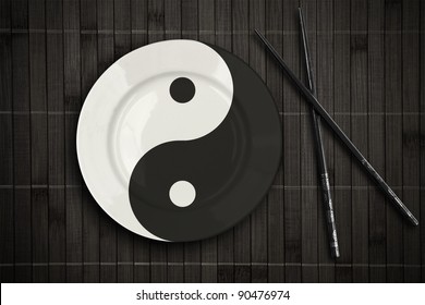 Yin Yang Plate Over Bamboo Placemat Setting With Chopsticks