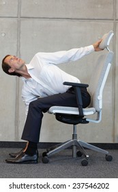 Yoga With Arm Chair In Office - Business Man Exercising