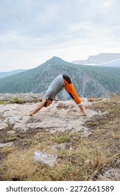Yoga asana on the top of the mountain, the guy practices yoga in nature, physical activity on the joints, health care, spiritual practices, mountain posture. High quality photo - Shutterstock ID 2272661589