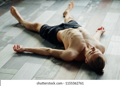 Yoga Asanas. Man Exercising Corpse Pose Or Savasana. Training And Relaxation Concept. Sport Fitness And Healthy Lifestyle.