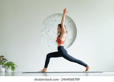 yoga, Asian woman wearing yoga clothes practicing yoga exercising healthy lifestyle in fitness studio. Sport activity, gymnastics or ballet dancing class. - Powered by Shutterstock