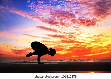 Yoga Bakasana Crane Pose By Woman In Silhouette With Dramatic Sunset Sky Background. Free Space For Text