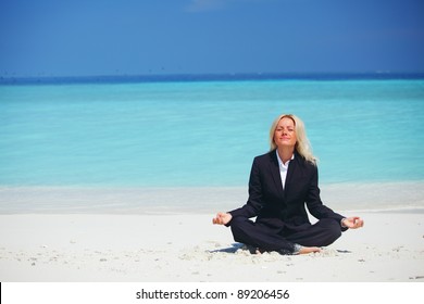 Yoga Business Woman In Lotus Pose On The Beach