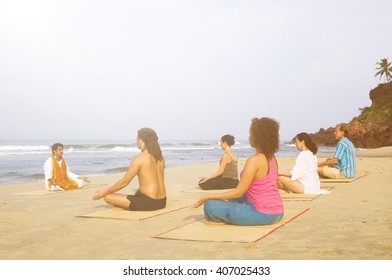 Yoga Class By The Beach Having Breathing Excercise.