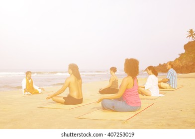 Yoga Class By The Beach Having Breathing Exercise.