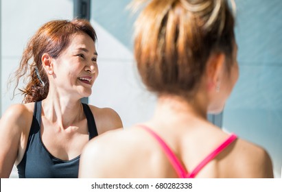 In Yoga Class Older Woman Smiling Happily.