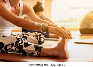 A Yoga Class Streching Legs