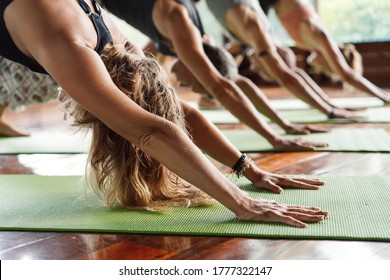 Yoga class in a tropical environment of a yoga meditation retreat. Hands close up