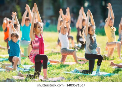 Yoga classes outside on the open air. Kids Yoga - Powered by Shutterstock