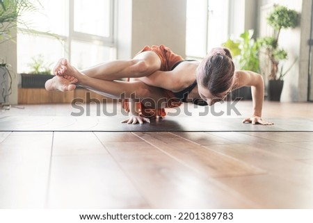 Yoga exercise pose asana, a young woman uses a mat.