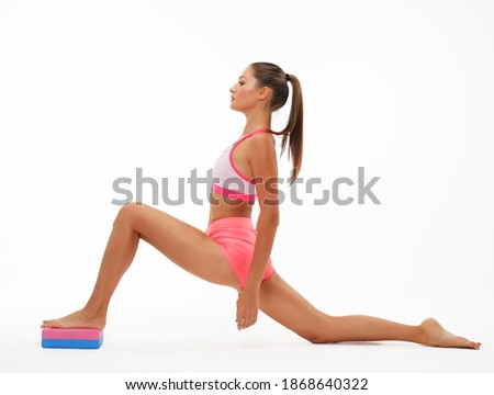 Yoga and fitness concept:Woman practicing yoga with yoga block over white background