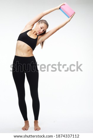 Yoga and fitness concept:Woman practicing yoga with yoga block over white background