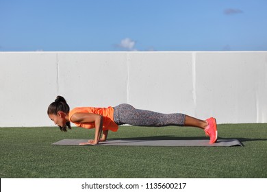 Yoga Fitness Woman Practicing Chaturanga Pose Push Ups Or Press Up On Exercise Mat At Outdoor Home. Fit And Healthy Young Girl Doing Morning Core Body Workout Push Up Strength Training.