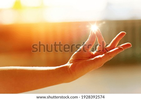 yoga, gesture and healthy lifestyle concept - hand of meditating yogi woman at studio showing gyan mudra