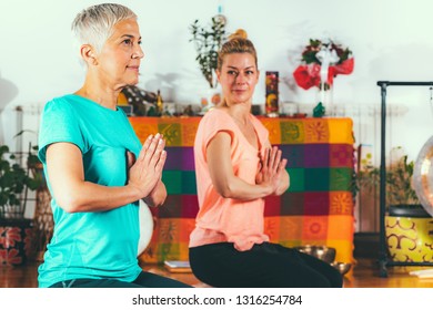 Yoga Guru With Senior Woman, Doing Yoga