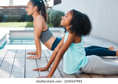 Yoga Helps Us Relax. Shot Of A Young Mother And Daughter Practicing Yoga Outside.