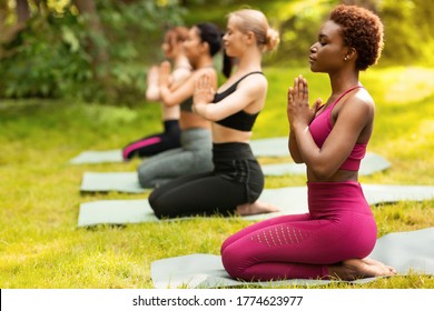 Yoga for inner balance. Group of diverse women meditating at park, copy space - Powered by Shutterstock