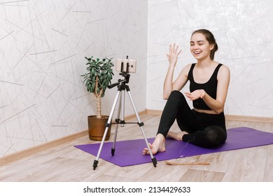 Yoga Instructor Recording Video On Smartphone In Room At Home. Female Yogi Coach Shooting Lesson Online On Mobile Phone 