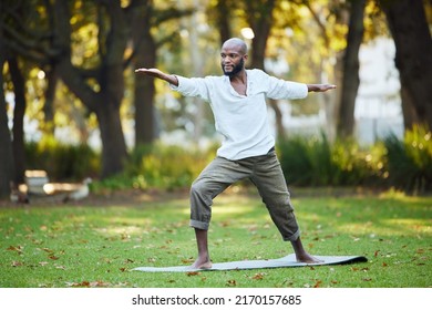 Yoga Keeps Him In Shape. Full Length Shot Of A Handsome Young Man Practicing Yoga Outside In The Park.