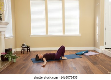 Yoga knees bent back on floor