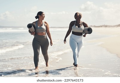 Yoga makes us feel like we can walk on water. two young women walking on the beach with their yoga mats. - Powered by Shutterstock