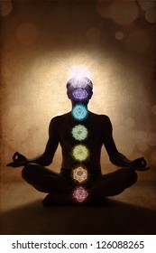Yoga man in lotus pose with chakra symbols