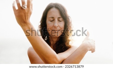 Yoga - Mature woman doing flow meditation exercise outdoors with sunset background - Healthy and mindful lifestyle concept - Soft focus on face ストックフォト © 