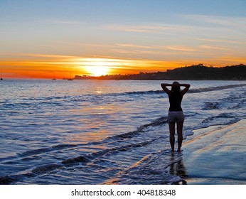 Yoga Meditation Concept. Woman Silhouette Meditation In Nature At Sunrise.   Inner Peace. 
West Beach.  Santa Barbara.  California. The United States. 