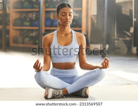 Yoga, meditation and Indian woman for wellness, mindfulness and breathing exercise on gym floor. Mental health, meditate and female person in lotus pose for calm mindset, zen and balance in training