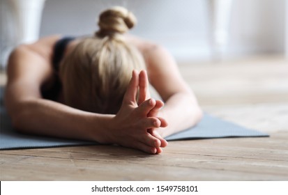 Yoga For Mind. Fit Young Woman Laying Face Down On Yoga Mat At Studio, Stretching, Empty Space