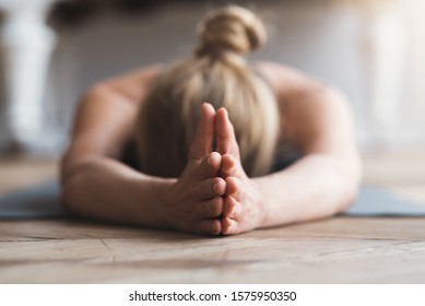 Yoga For Mind. Young Woman Laying Face Down On Yoga Mat At Studio, Meditating