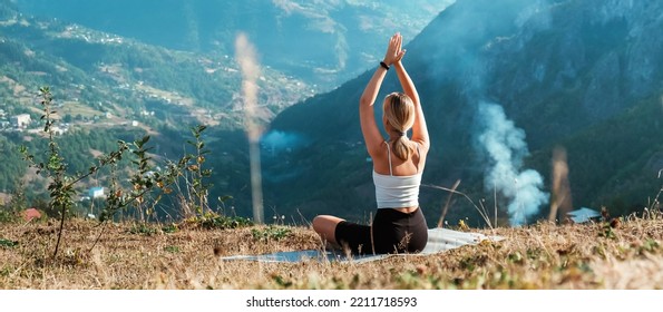 yoga in the mountains. Girl generation z practices in the mountains. Wellness, mental health, meditation, self care, physical health, physical fitness and outdoor sports.
