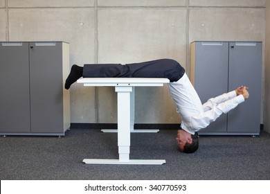 Yoga In Office. Business Man Exercising At Workplace