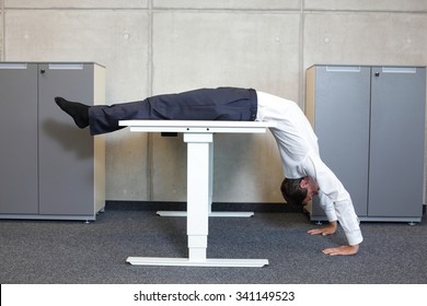 Yoga In Office. Business Man Exercising At Workplace