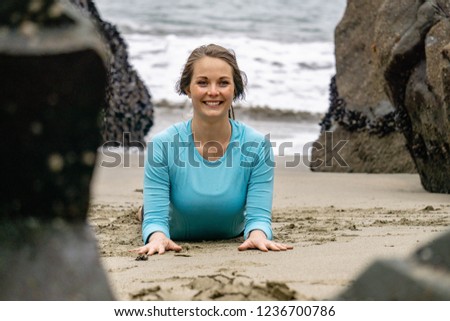 Yoga on the beach with a beautiful, brunette, strong women in San Francisco near the Golden Gate bridge on a California beach.