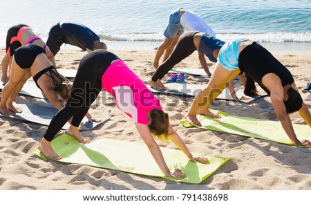Yoga on beach, group of people practicing healthy lifestyle