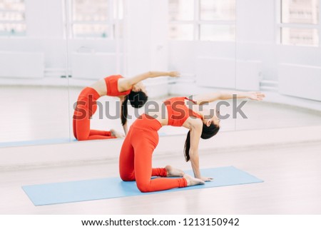 Yoga on the floor. Exercise with a Mat with a beautiful girl. Relax and stretch stand.