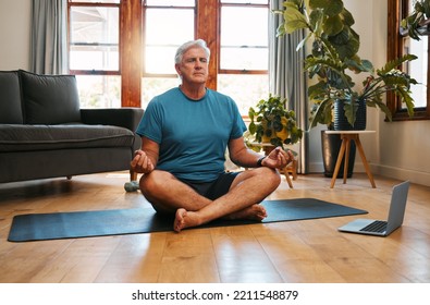 Yoga, online and meditation with a senior man following a zen fitness class for workout, exercise and training. Laptop, health and retirement with an elderly male pensioner exercising in his home - Powered by Shutterstock