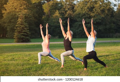 Yoga At Park, Group Of Mixed Age Women Doing Pose While Sunset