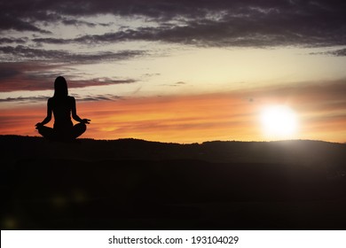 Yoga practicioner during the sunset meditation - Shutterstock ID 193104029
