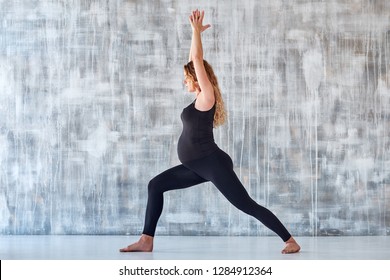 Yoga. Pregnant woman practicing yoga meditation in studio. Health lifestyle concept and baby care.