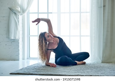 Yoga. Pregnant woman practicing yoga meditation in home. Health lifestyle concept and baby care.